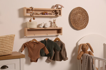 Nursery interior with stylish furniture, clothes and accessories