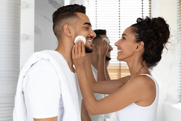 Portrait Of Happy Arab Couple Making Beauty Routine In Bathroom Together