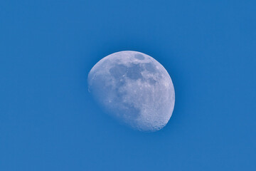 The waning moon with blue sky in march