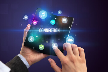 Businessman holding a foldable smartphone