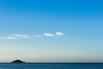 Island in the middle of the sea with evening sky with lovely clouds