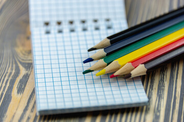 Sharpened pencils and notebook. Colored.