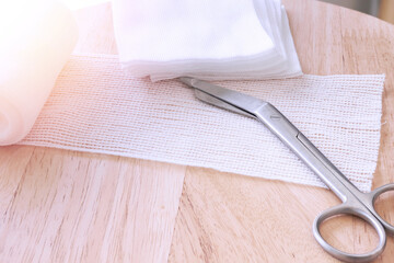 Dressing or clean wound tools includes Roll gauze,pile of gauzes and gauze roll cutter or scissors