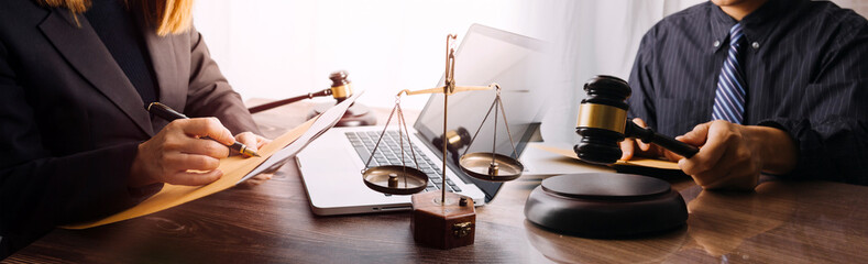 Male lawyer working with contract papers and wooden gavel on tabel in courtroom. justice and law ,attorney, court judge, concept.