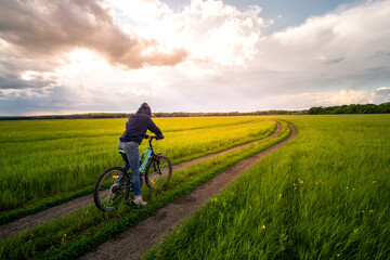 Fototapeta premium young woman is biking in the nature.