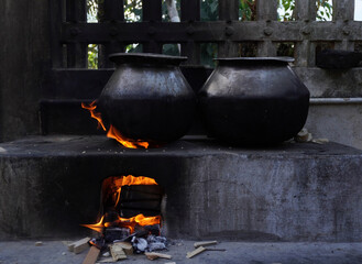 Hot heat and black charcoal. Cooking outdoors . Traditional pot in hot coals and ashes .