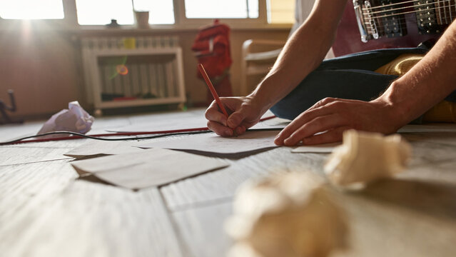 Partial Image Of Man Writing Text Of New Song