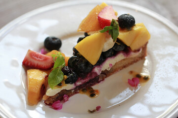 Fresh fruit tart  on white plate - obrazy, fototapety, plakaty