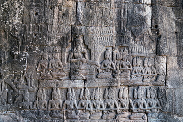 Stone-carved bas-relief with Shiva in meditation in ancient Khmer temple, Angkor Siem Reap Cambodia