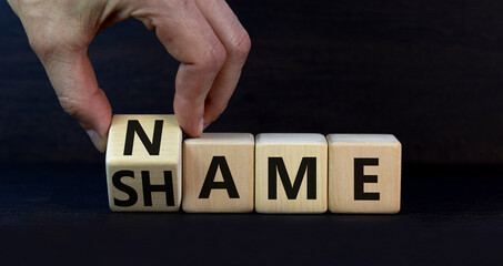 Name or shame symbol. Businessman turns the wooden cube and changes the concept word Shame to Name....
