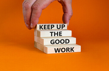 Keep up the good work symbol. Concept words Keep up the good work on wooden blocks. Businessman hand. Beautiful orange table orange background. Keep up the good work business concept. Copy space.