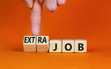 Extra job symbol. Businessman turns wooden cubes and changes concept words Job to Extra job....