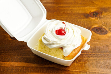 Tres leches cake in a takeout container