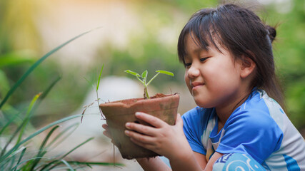 Cute kid planting a tree for help to prevent global warming or climate change and save the earth....