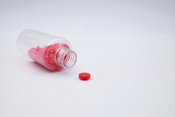 red round pills in a bottle on a white background. Pills for maintaining the heart in a package.