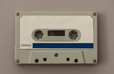 audio cassette tape isolated on beige background. Close up view.