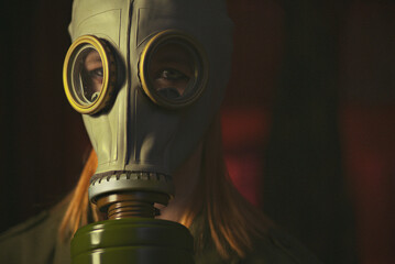 military girl in a gas mask against radiation