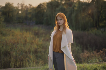 a girl stands in a green forest in spring