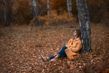 girl in the autumn in the leaves in the forest