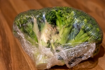 Fresh broccoli heads plastic wrapped for freshness