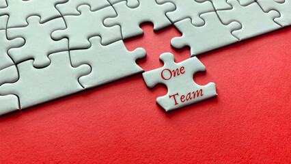 Motivational and inspirational quote on missing jigsaw puzzle - One Team.