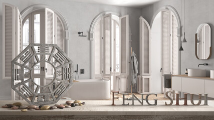 Fototapeta premium Wooden vintage table shelf with ba gua and 3d letters making the word feng shui over minimalist bathroom in classic apartment, freestanding bathtub, decor, zen concept interior design