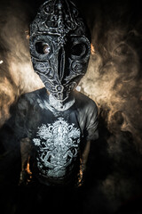 scary sorcerer in smoke. voodoo rite