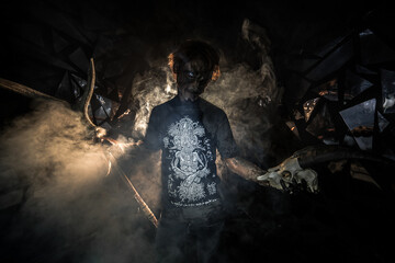 scary sorcerer in smoke. voodoo rite