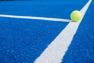 Bright blue tennis, paddle ball or pickleball court close up of service line outdoors. selective...