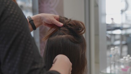 Fototapeta premium Beautiful girl at the hairdresser. The girl got her hair done. Beauty salon