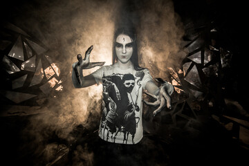 the sorceress stands in the smoke. voodoo rite