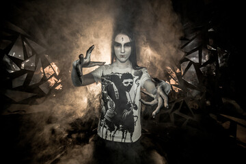 the sorceress stands in the smoke. voodoo rite