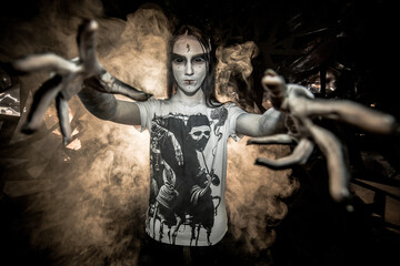 the sorceress stands in the smoke. voodoo rite