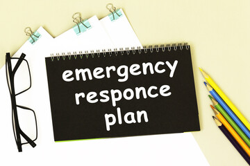 EMERGENCY RESPONCE PLAN Business text memo on black paper.