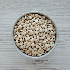 Raw Organic Dry White Beans in a Gray Bowl, top view. Flat lay, overhead, from above.