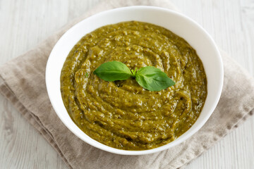 Homemade Green Pesto in a White Bowl, side view.