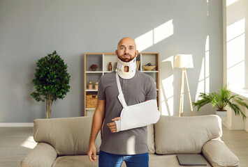 Portrait of shocked injured young man with bandage on arm and neck after accident or trauma....