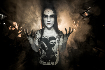 the sorceress stands in the smoke. voodoo rite