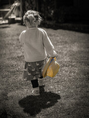 Child walking away with sun hat
