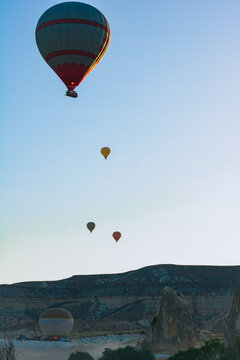 Hot air balloons at sunrise in Cappadocia vertical photo.