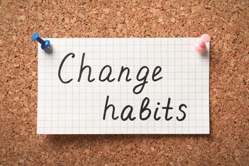 Sheet of paper with phrase Change Habits pinned to corkboard