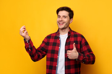 Excited man holding something in hand showing like