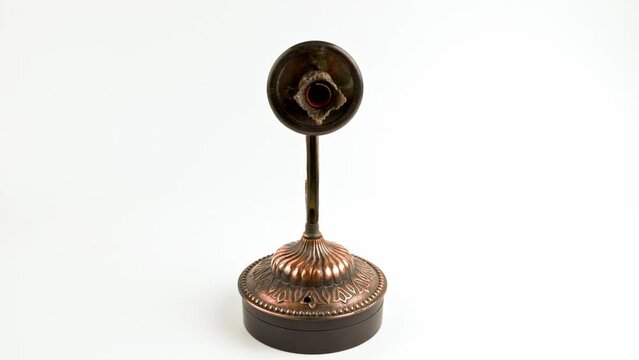 fake bronze sconce spinning on turning table on white background