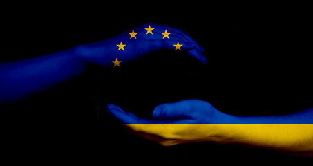 Europe union and Ukraine flags and hands on black background, peace and NATO concept