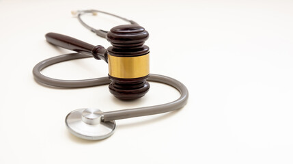 Healthcare Law. Medical stethoscope and judge gavel isolated on white