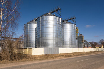 Fototapeta na wymiar agro silos granary elevator on agro-processing manufacturing plant for processing drying cleaning and storage of agricultural products, flour, cereals and grain.