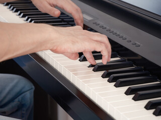 A man playing on a piano. Close up.