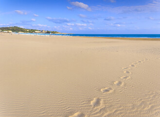 Fototapeta na wymiar Footprints on the beach. The most beautiful beaches of Puglia, Italy: San Lorenzo Beach in Vieste. Gargano coast: Bay of Vieste, (Apulia) Italy.