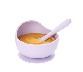 Plastic dishware with healthy baby food on white background