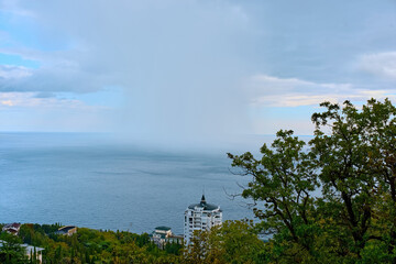 A rain front from the sea approaches the shore. View from the Sunny Path to the sea.